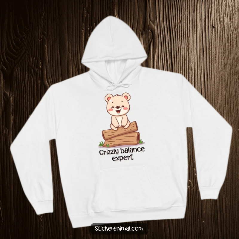 Funny hoodie with a happy bear cub balancing on a log, offering cozy comfort and woodland humor.