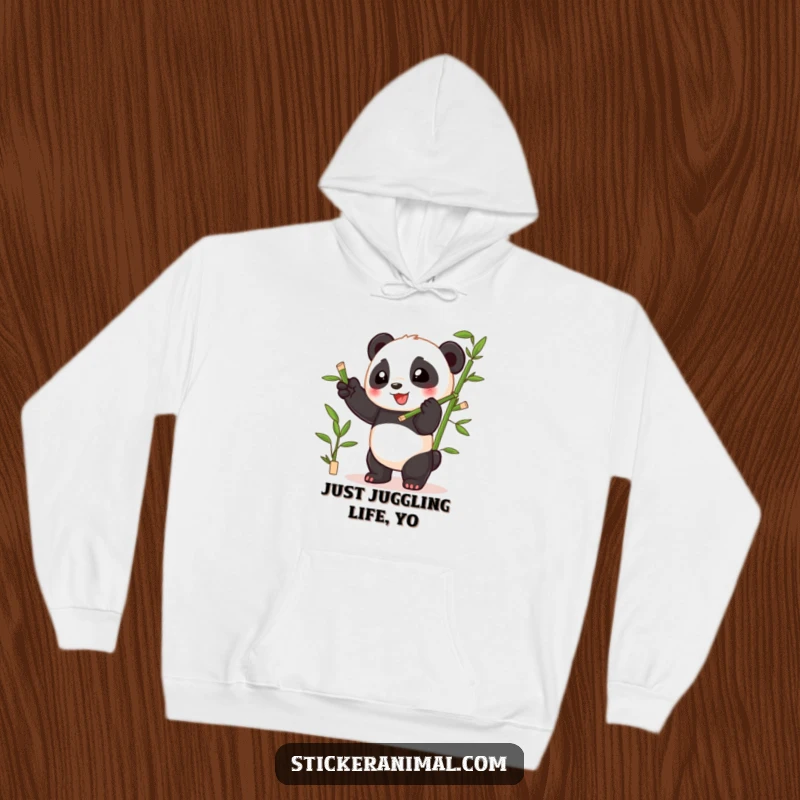 Funny playful panda cub juggling bamboo shoots with glee, printed on a soft and warm hoodie for cozy comfort.
